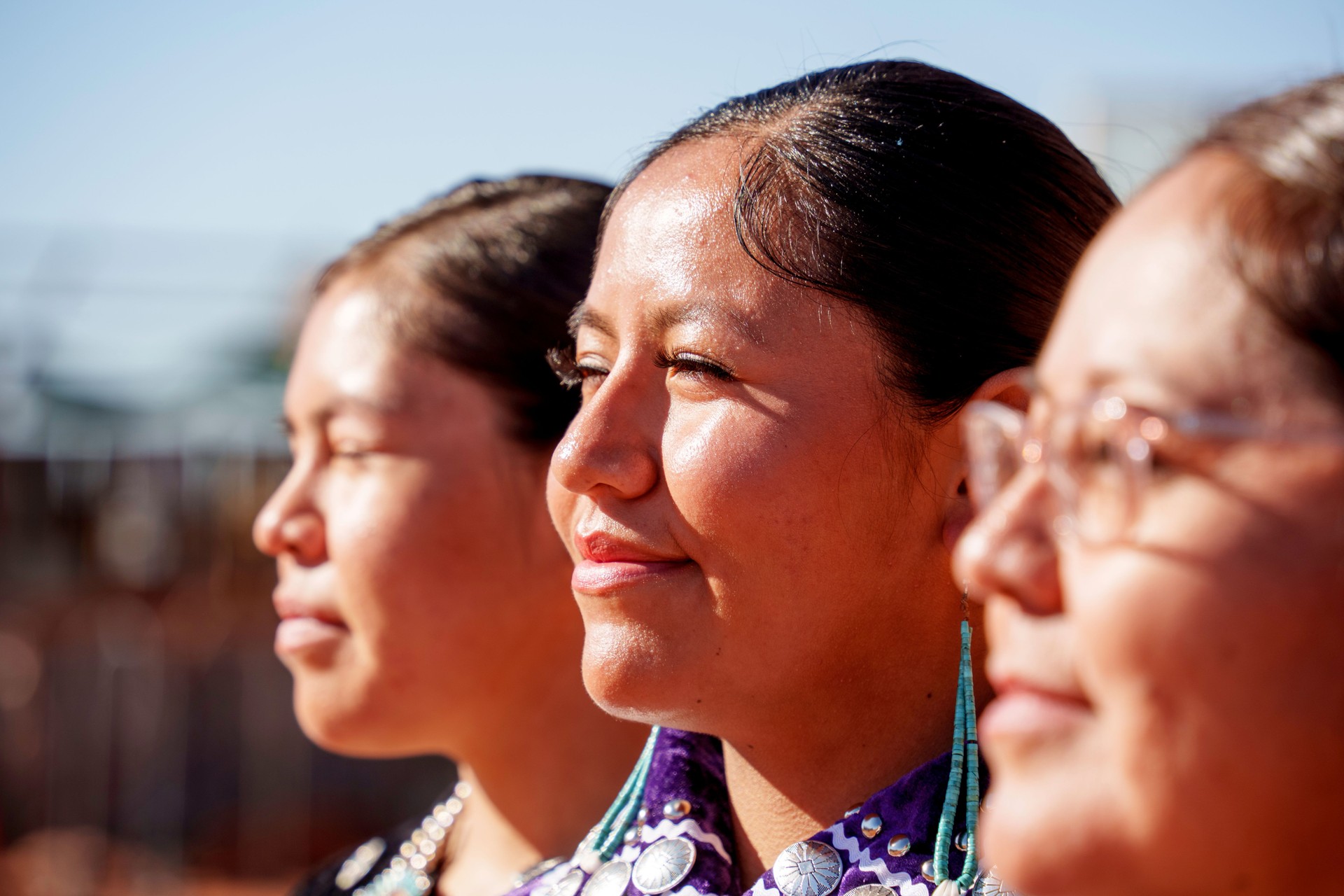 Shallow Depth of Field Portrait Three Women, mother and two daughters in Line Profile View Indigenous Navajo Family in Monument Valley Utah