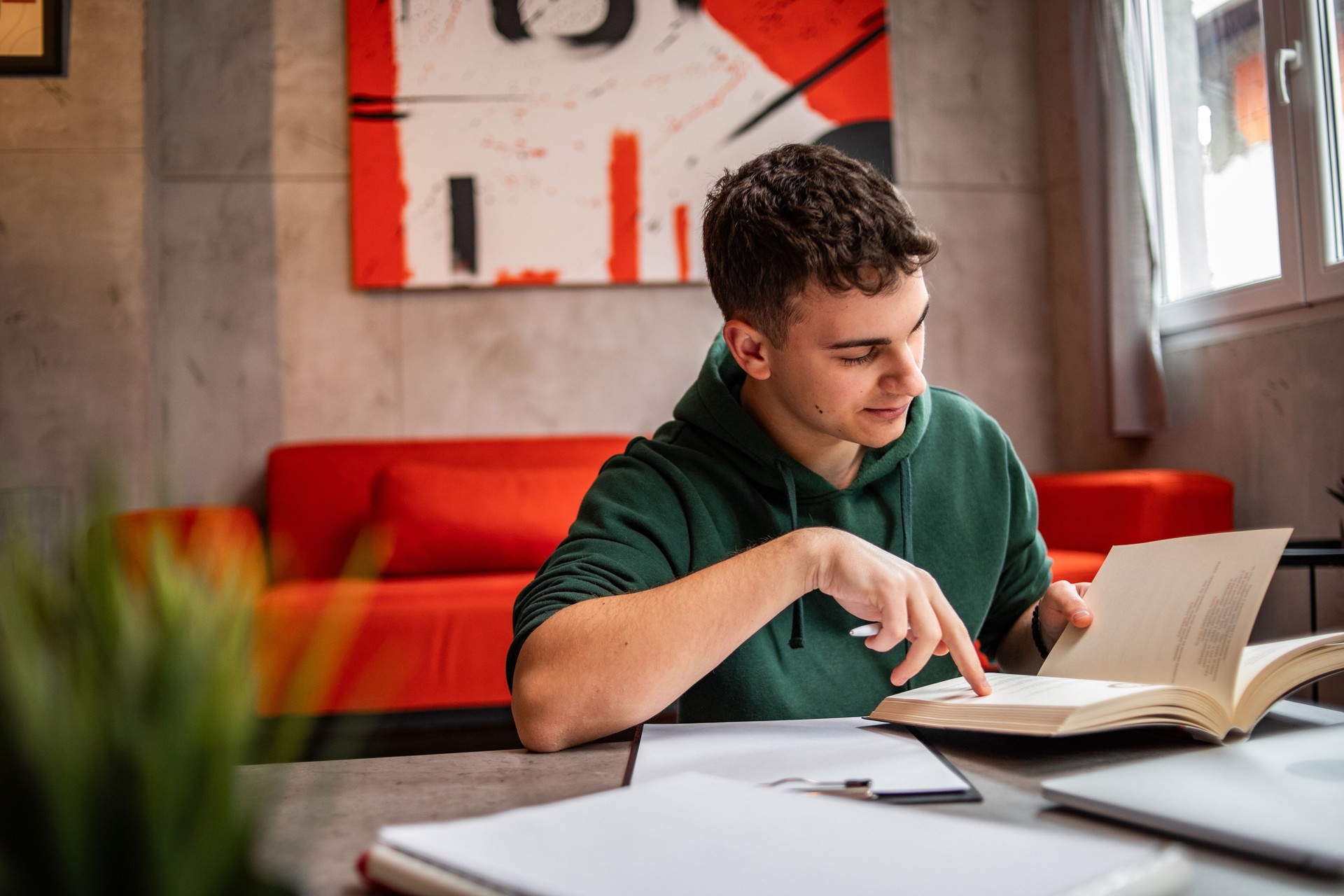 A young teenage student is studying at home